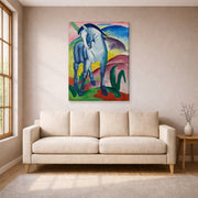 Gallery-wrapped canvas print of Franz Marc's Blue Horse displayed on a wall in a living room