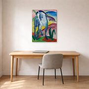 Gallery-wrapped canvas print of Franz Marc's Blue Horse displayed on a wall in an office