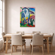 Unframed poster print of Franz Marc's Blue Horse displayed on a wall in a dining room