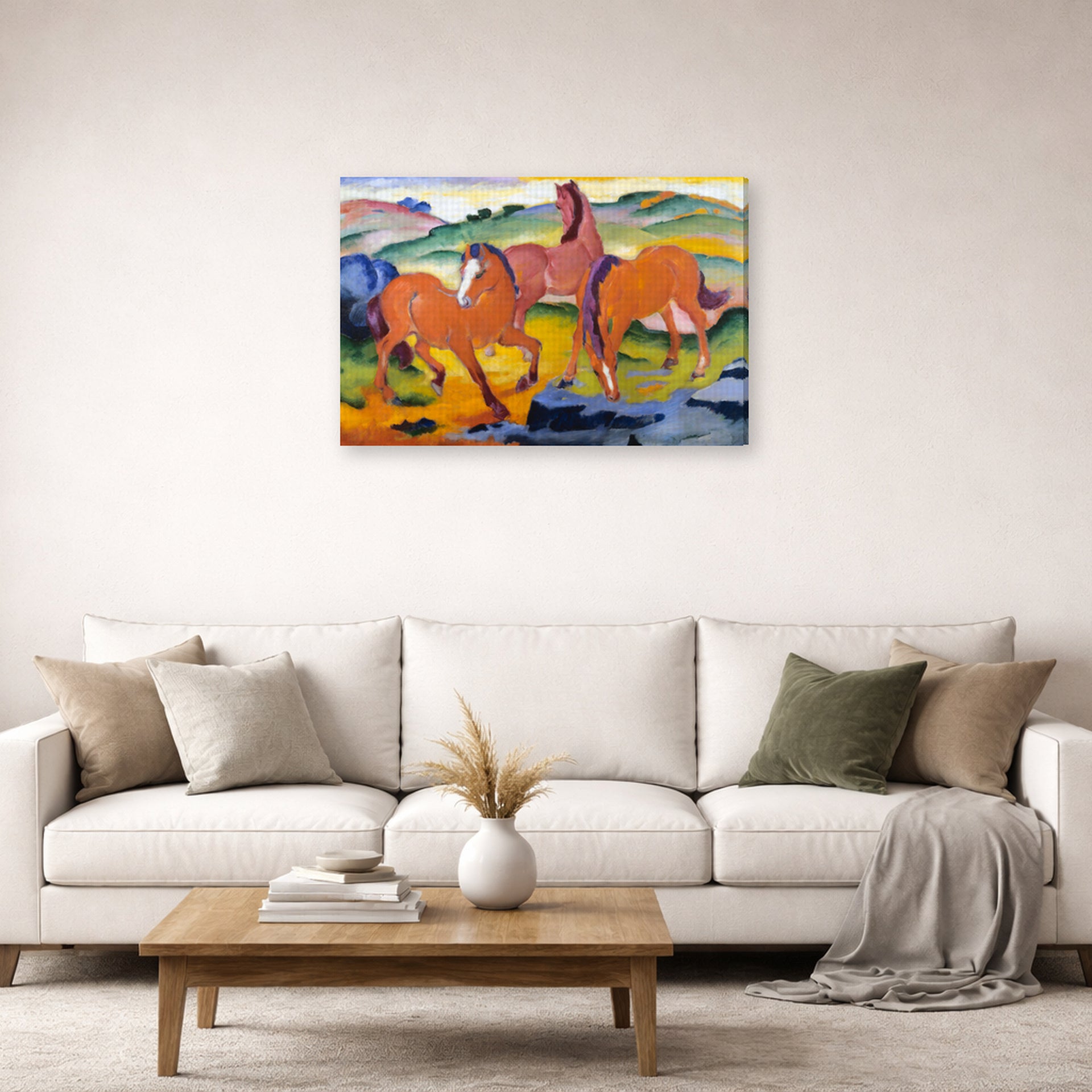 Gallery-wrapped canvas print of Franz Marc's Grazing Horses IV (The Red Horses) displayed on a wall in a living room