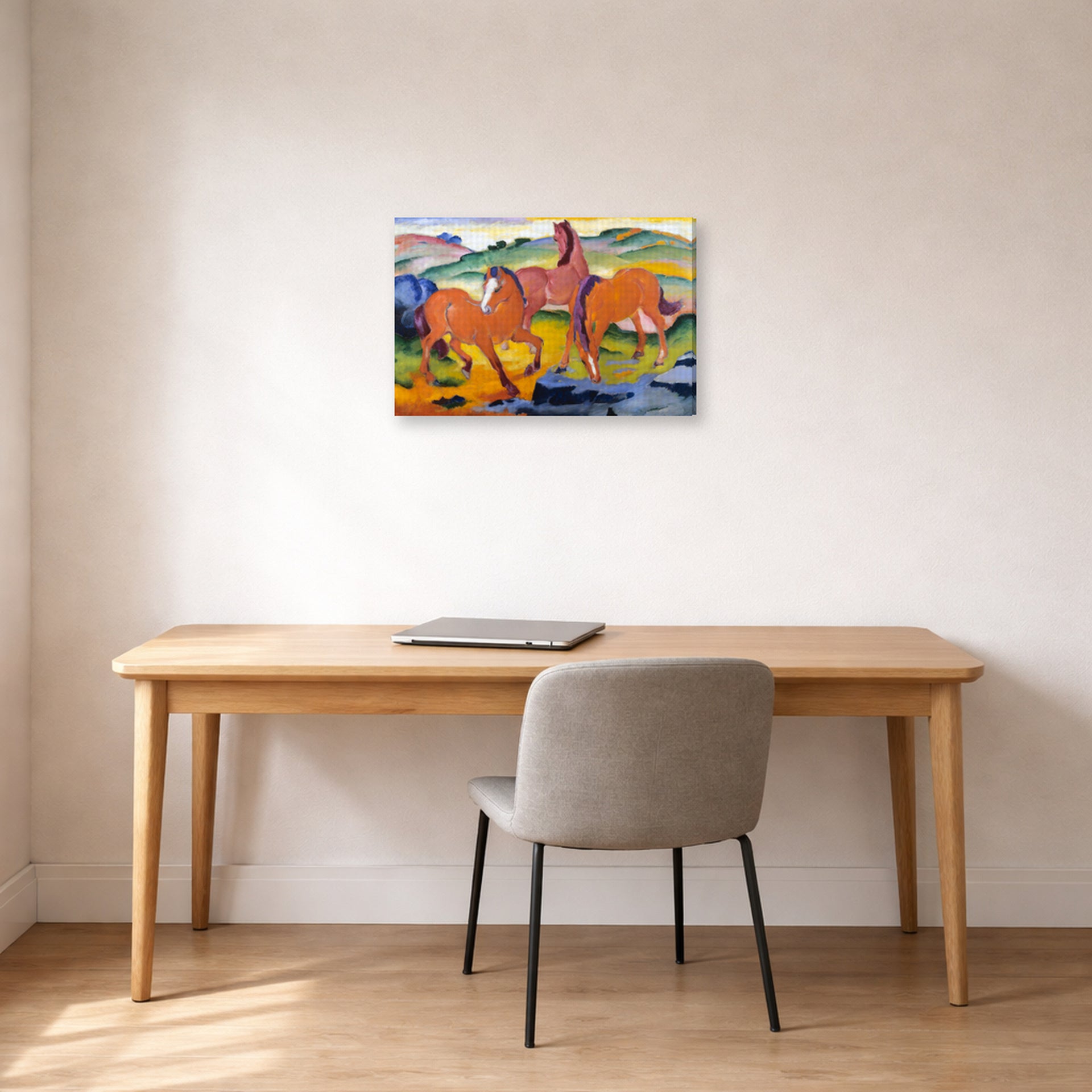 Gallery-wrapped canvas print of Franz Marc's Grazing Horses IV (The Red Horses) displayed on a wall in an office