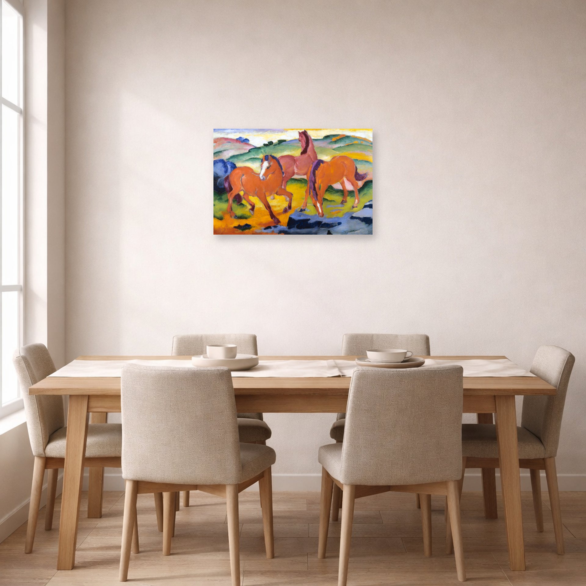 Unframed poster print of Franz Marc's Grazing Horses IV (The Red Horses) displayed on a wall in a dining room