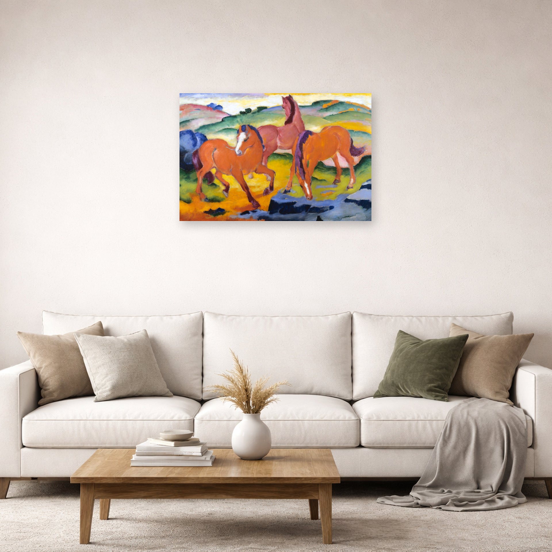 Unframed poster print of Franz Marc's Grazing Horses IV (The Red Horses) displayed on a wall in a living room