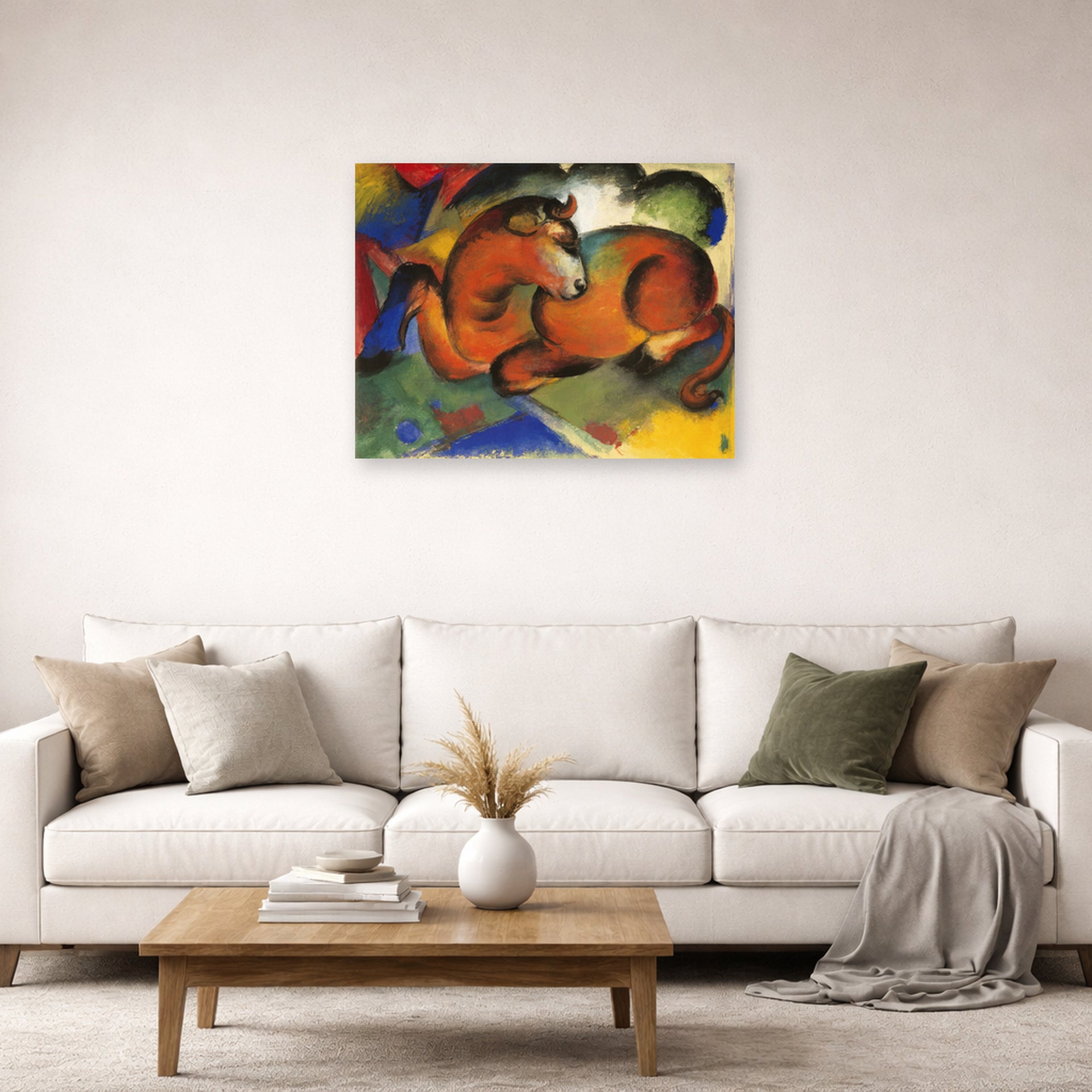 Unframed poster print of Franz Marc's Red Bull displayed on a wall in a living room