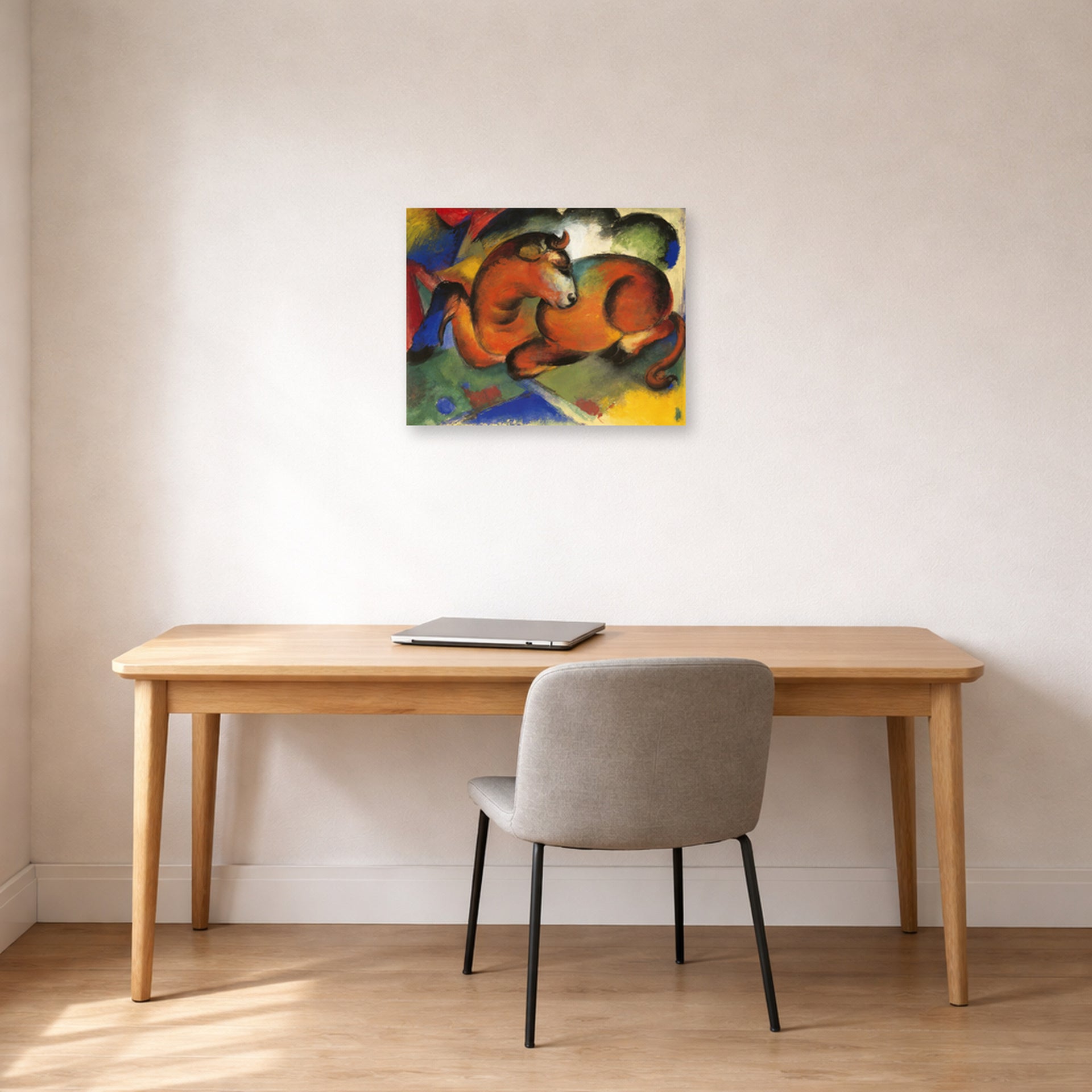 Unframed poster print of Franz Marc's Red Bull displayed on a wall in an office