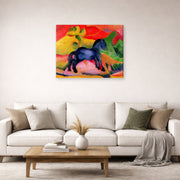 Gallery-wrapped canvas print of Franz Marc's The Little Blue Horse displayed on a wall in a living room