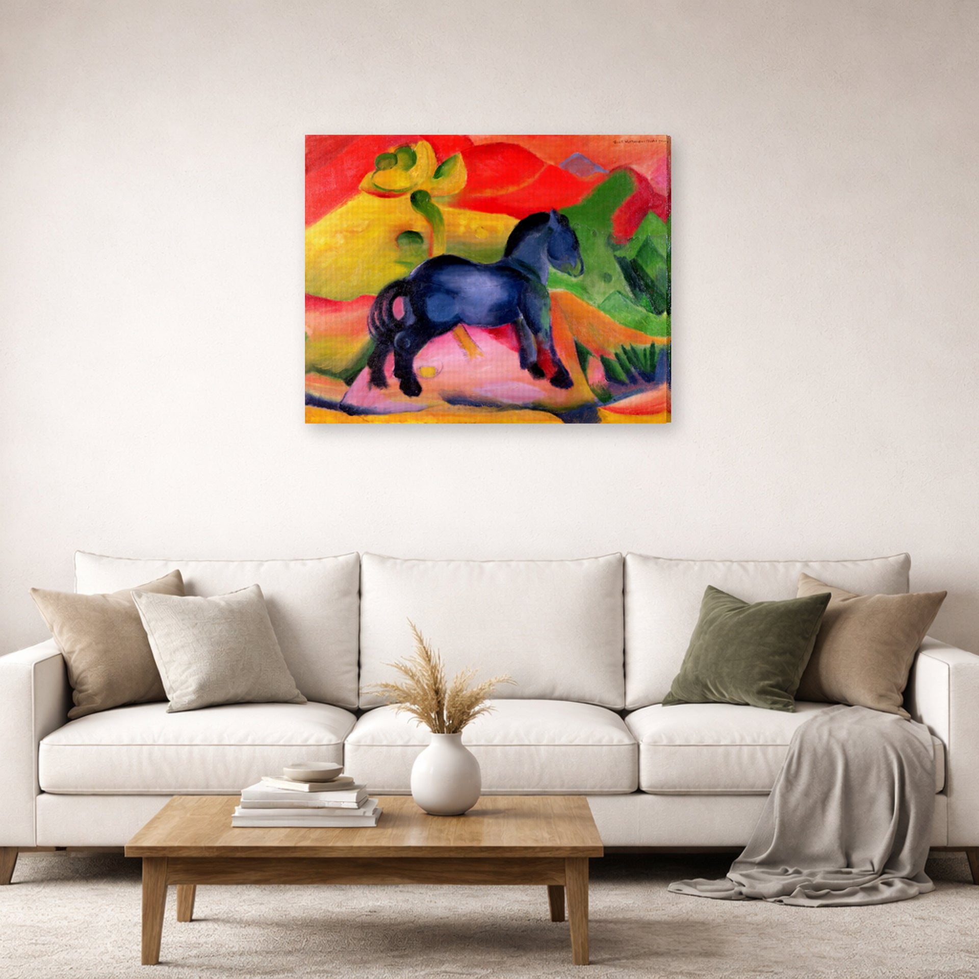 Gallery-wrapped canvas print of Franz Marc's The Little Blue Horse displayed on a wall in a living room