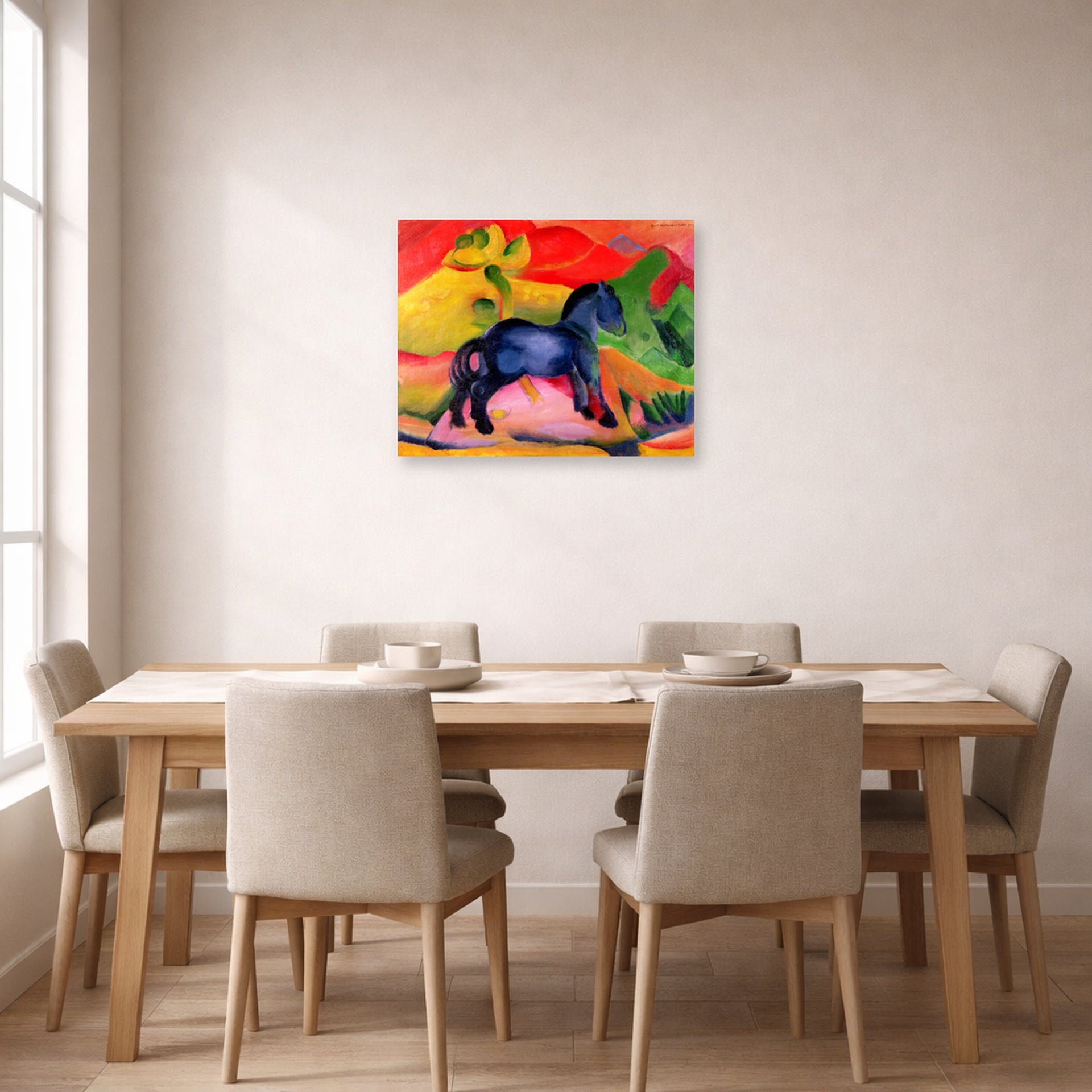 Unframed poster print of Franz Marc's The Little Blue Horse displayed on a wall in a dining room
