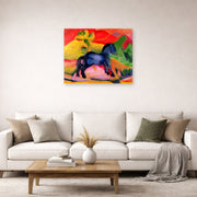Unframed poster print of Franz Marc's The Little Blue Horse displayed on a wall in a living room