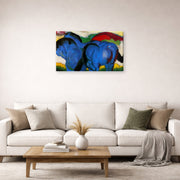 Gallery-wrapped canvas print of Franz Marc's The Little Blue Horses displayed on a wall in a living room