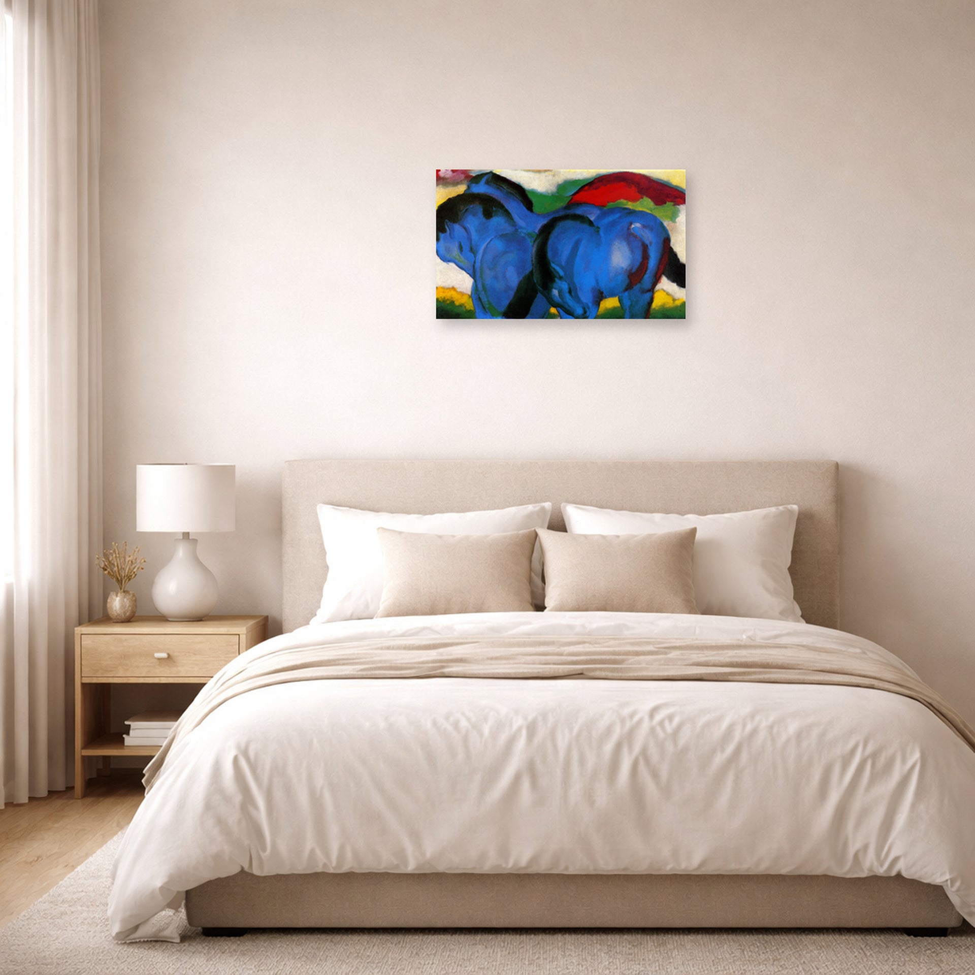 Unframed poster print of Franz Marc's The Little Blue Horses displayed on a wall in a bedroom