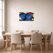 Unframed poster print of Franz Marc's The Little Blue Horses displayed on a wall in a dining room