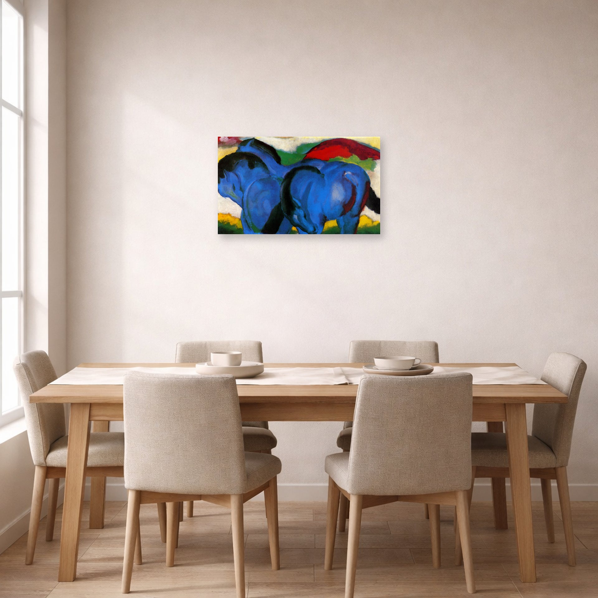 Unframed poster print of Franz Marc's The Little Blue Horses displayed on a wall in a dining room
