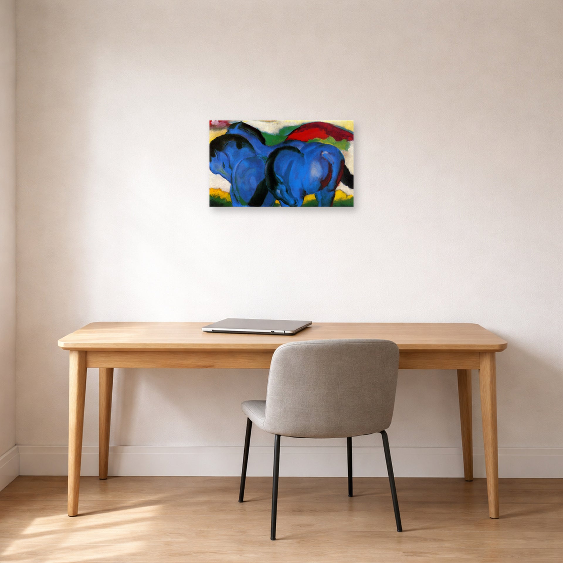 Unframed poster print of Franz Marc's The Little Blue Horses displayed on a wall in an office