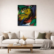 Unframed poster print of Franz Marc's The Tiger displayed on a wall in a living room