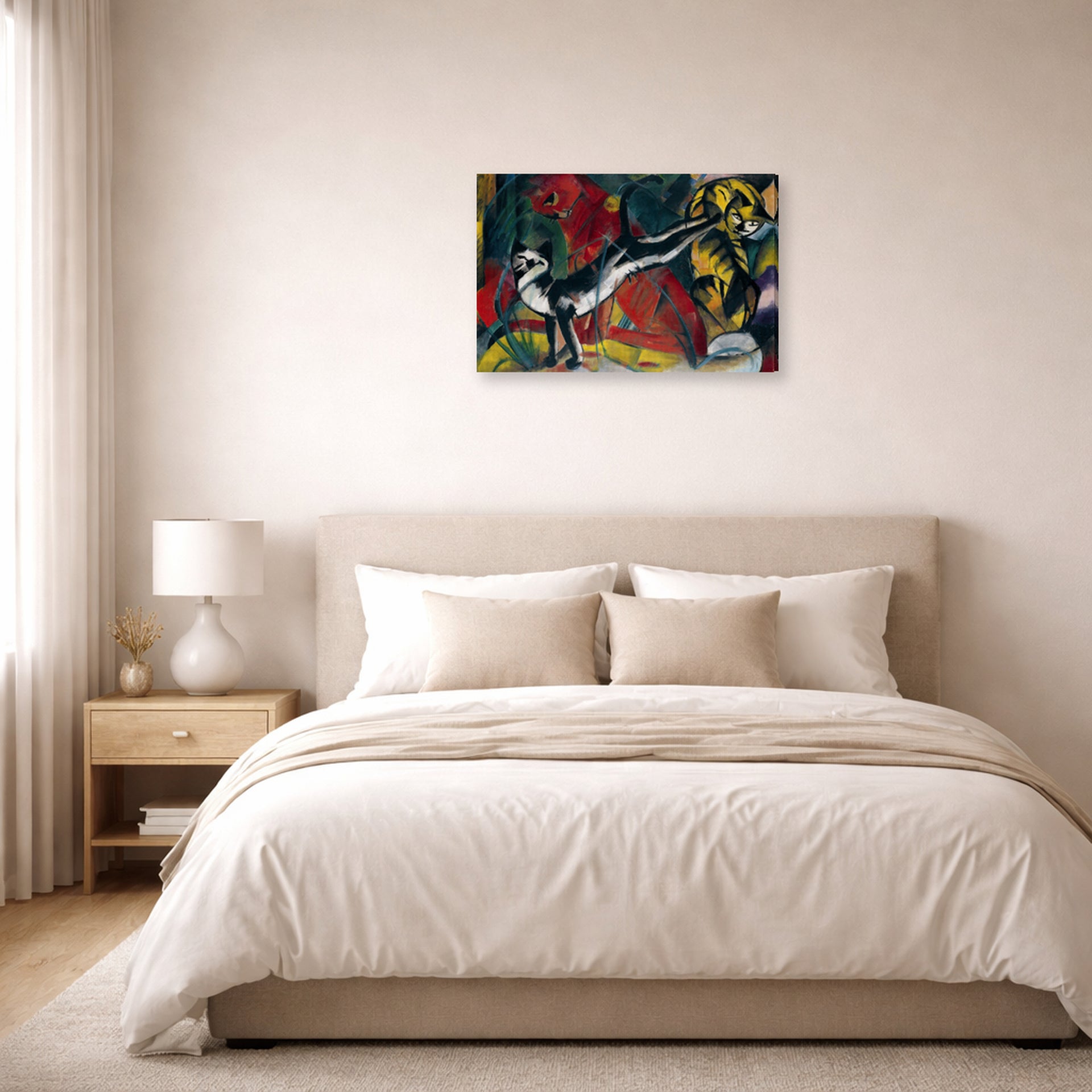 Gallery-wrapped canvas print of Franz Marc's Three Cats displayed on a wall in a bedroom