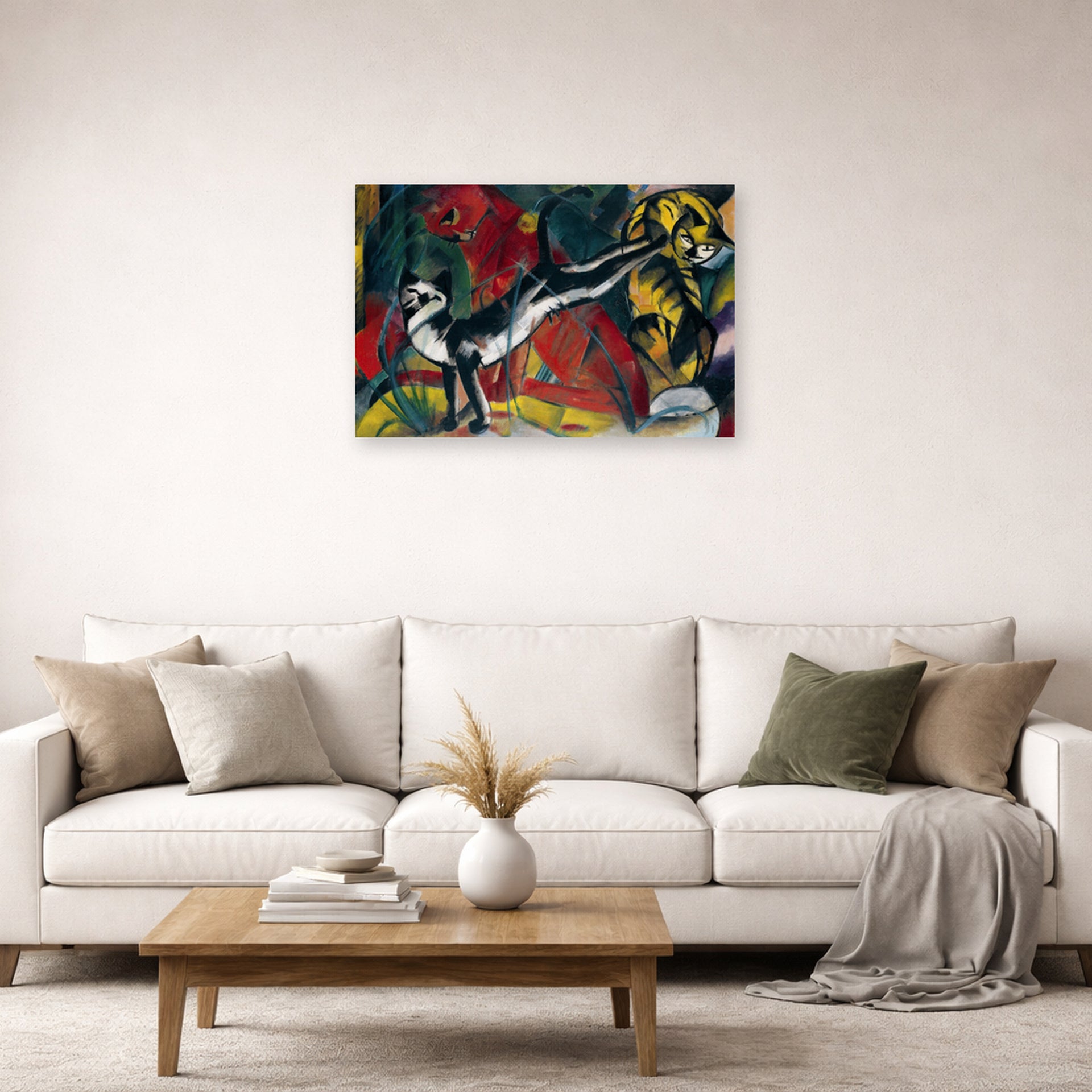 Unframed poster print of Franz Marc's Three Cats displayed on a wall in a living room