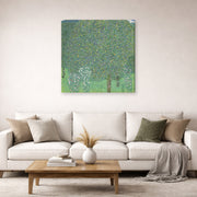 Gallery-wrapped canvas print of Gustav Klimt's 'Rose Bushes Under Trees' displayed on a wall in a living room (image 2 of 2)