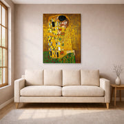 Gallery-wrapped canvas print of Gustav Klimt's 'The Kiss' displayed on a wall in a living room (image 1 of 2)