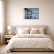 Gallery-wrapped canvas print of Gustave Caillebotte's The Seine and the Railroad Bridge at Argenteuil displayed on a wall in a bedroom