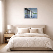 Unframed poster print of Gustave Caillebotte's The Seine and the Railroad Bridge at Argenteuil displayed on a wall in a bedroom
