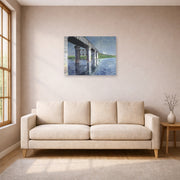 Unframed poster print of Gustave Caillebotte's The Seine and the Railroad Bridge at Argenteuil displayed on a wall in a living room