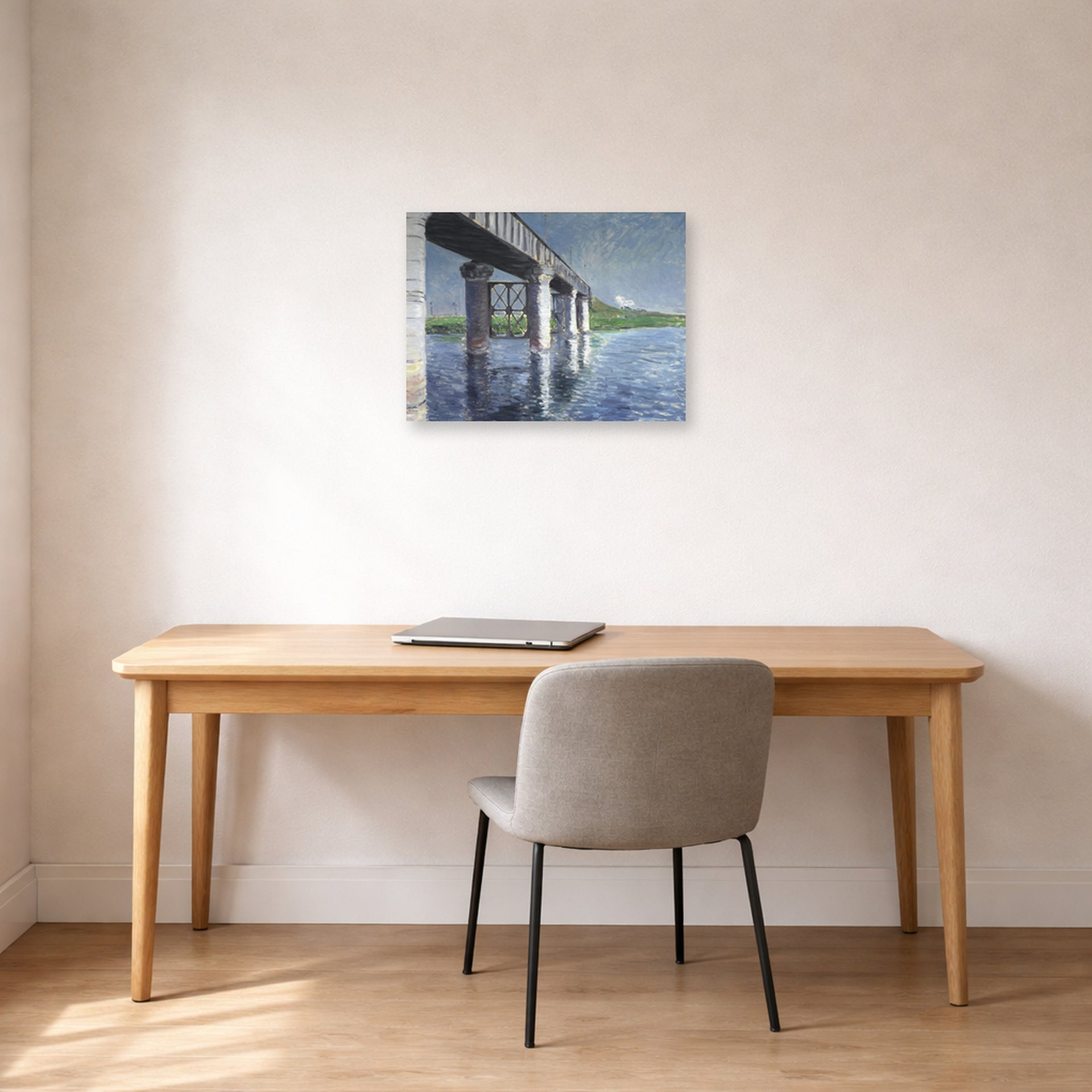 Unframed poster print of Gustave Caillebotte's The Seine and the Railroad Bridge at Argenteuil displayed on a wall in a office