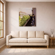 Gallery-wrapped canvas print of Gustave Caillebotte's Un balcon displayed on a wall in a living room
