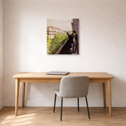 Unframed poster print of Gustave Caillebotte's Un balcon displayed on a wall in a office