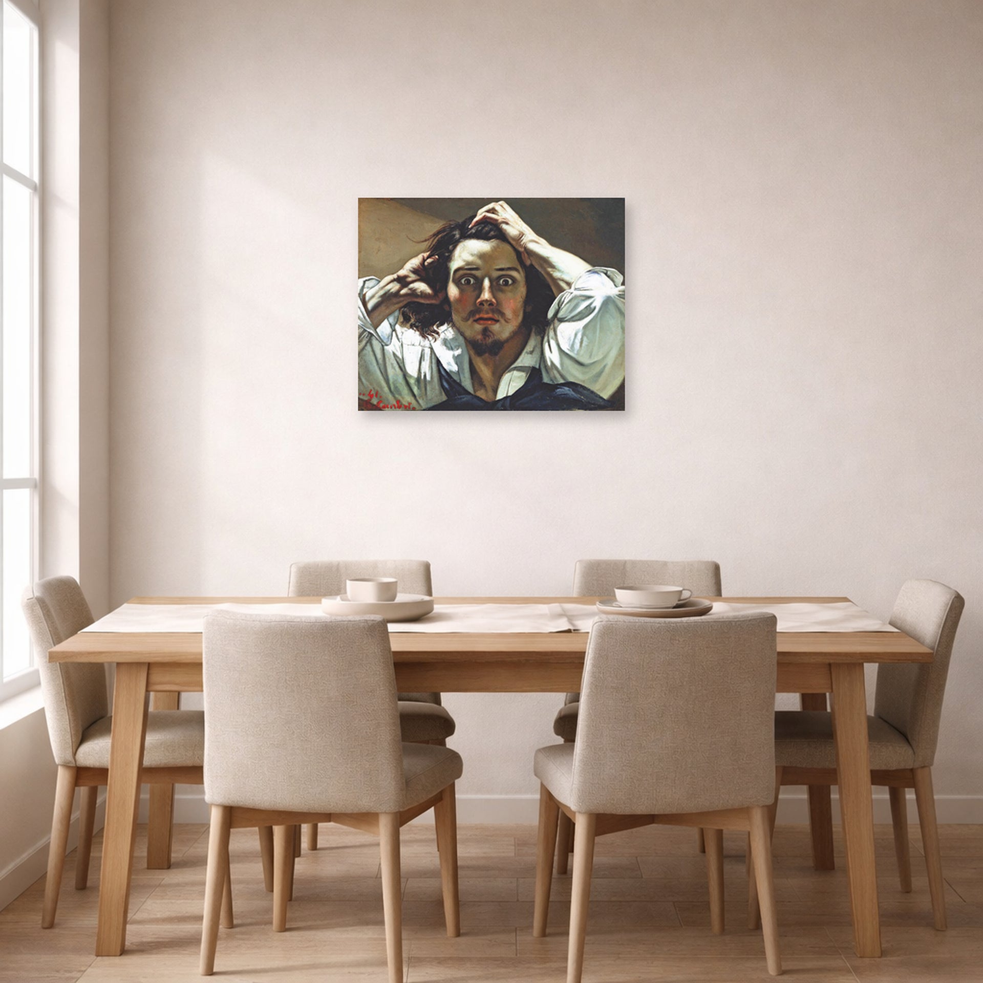 Unframed poster print of Gustave Courbet's Selfportrait (The Desperate Man) displayed on a wall in a dining room