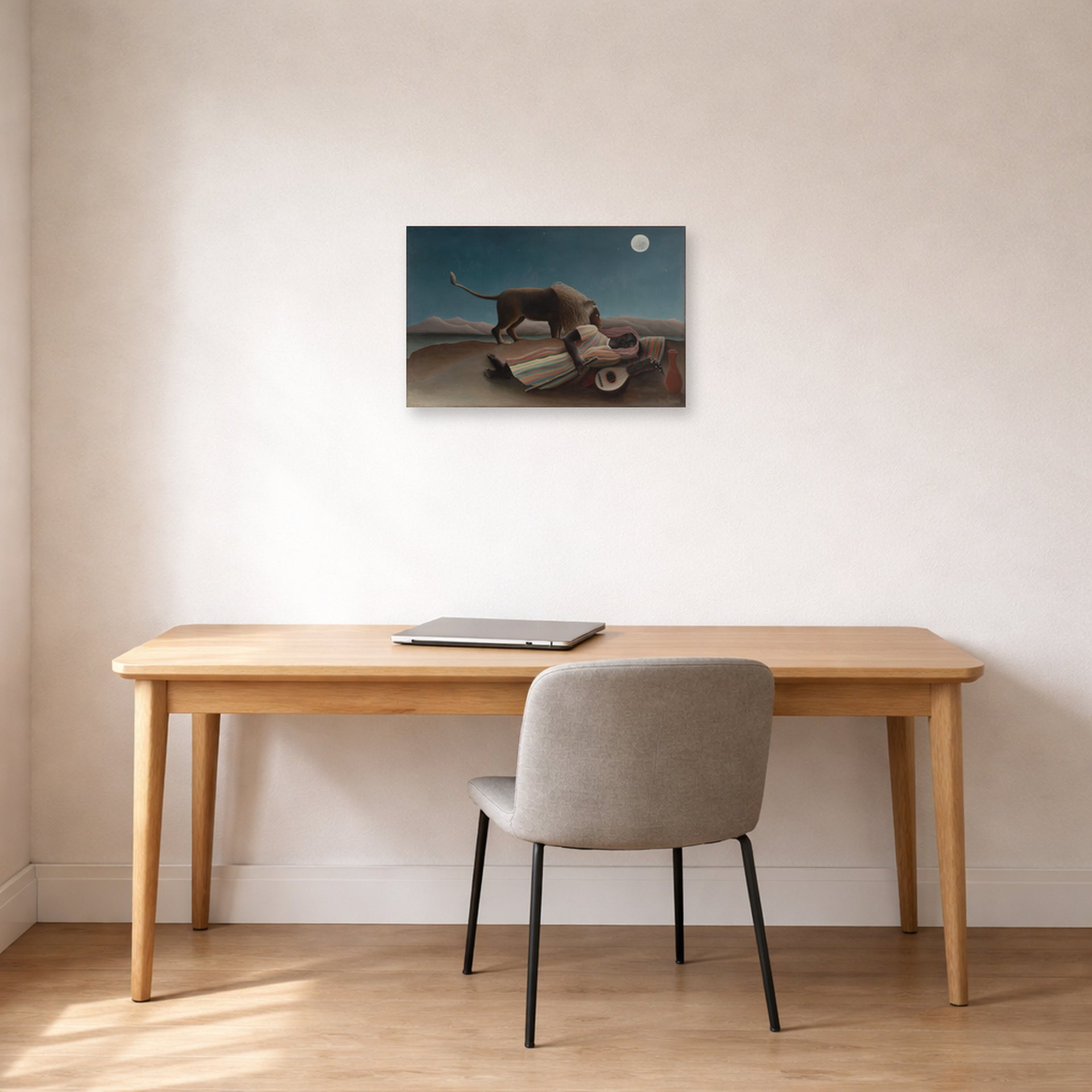 Unframed poster print of Henri Rousseau's La Bohémienne endormie, The Sleeping Gypsy displayed on a wall in a home office