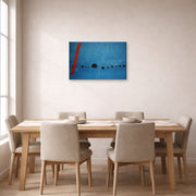 Gallery-wrapped canvas print of Joan Miró's 'Blue' displayed on a wall in a dining room