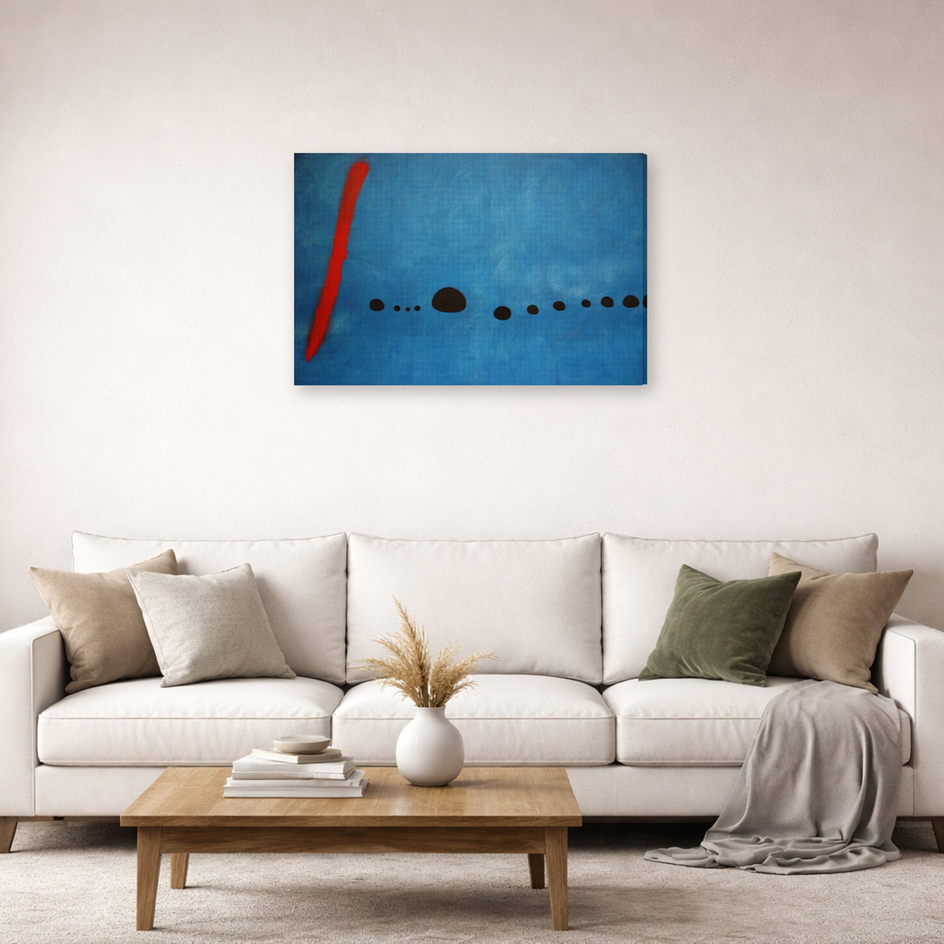 Gallery-wrapped canvas print of Joan Miró's 'Blue' displayed on a wall in a living room