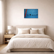 Unframed poster print of Joan Miró's 'Blue' displayed on a wall in a bedroom