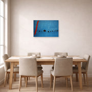 Unframed poster print of Joan Miró's 'Blue' displayed on a wall in a dining room