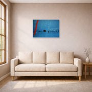 Unframed poster print of Joan Miró's 'Blue' displayed on a wall in a living room