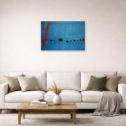 Unframed poster print of Joan Miró's 'Blue' displayed on a wall in a living room