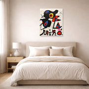 Unframed poster print of Joan Miró's 'Fundacao Calouste Gulbenkian' displayed on a wall in a bedroom