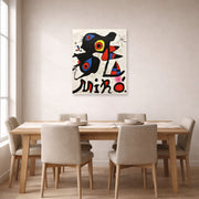 Unframed poster print of Joan Miró's 'Fundacao Calouste Gulbenkian' displayed on a wall in a dining room