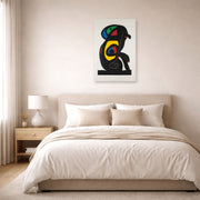 Unframed poster print of Joan Miró's 'La Brahmane' displayed on a wall in a bedroom
