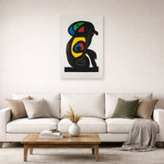 Unframed poster print of Joan Miró's 'La Brahmane' displayed on a wall in a living room