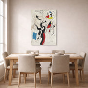 Gallery-wrapped canvas print of Joan Miró's 'Man and Woman' displayed on a wall in a dining room