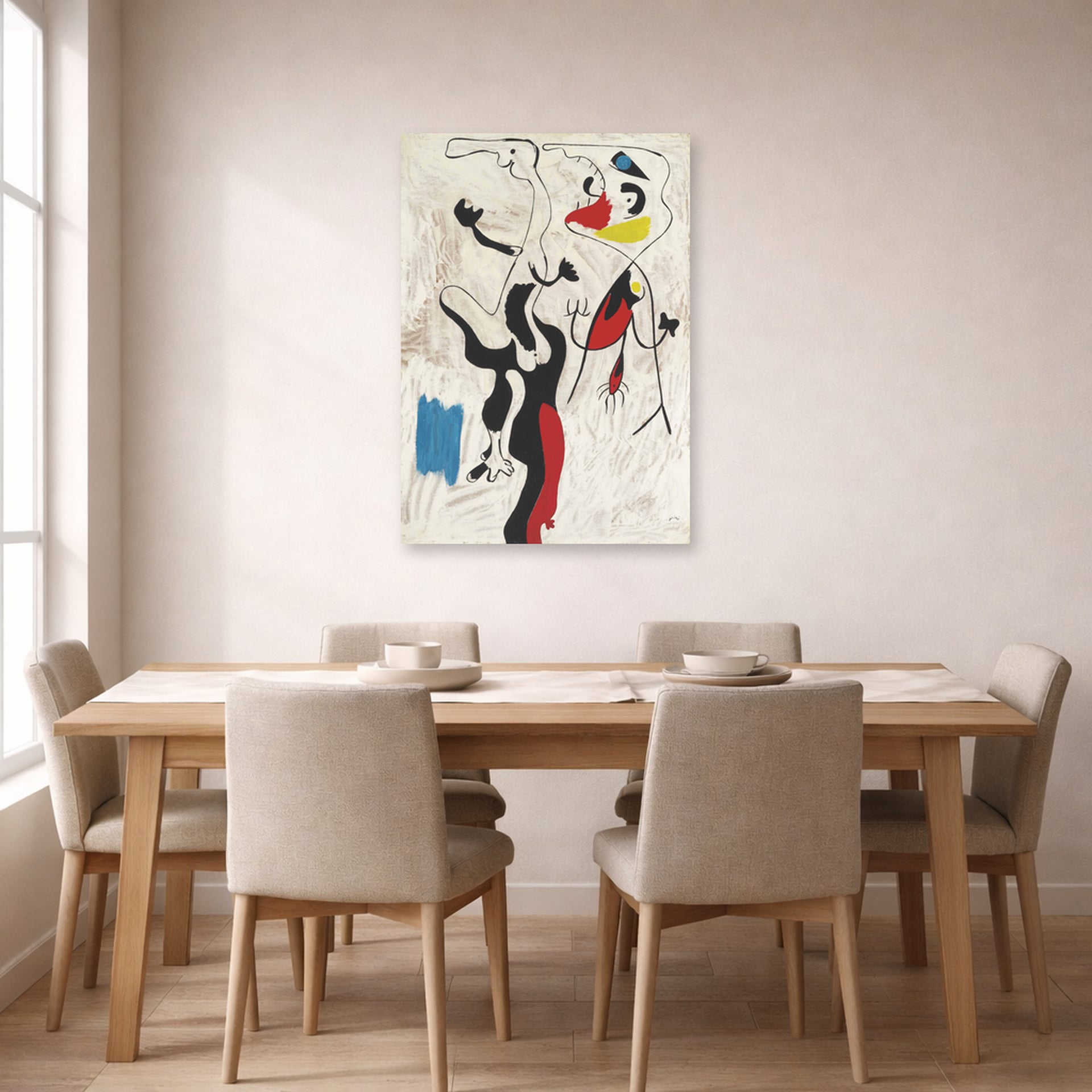 Unframed poster print of Joan Miró's 'Man and Woman' displayed on a wall in a dining room