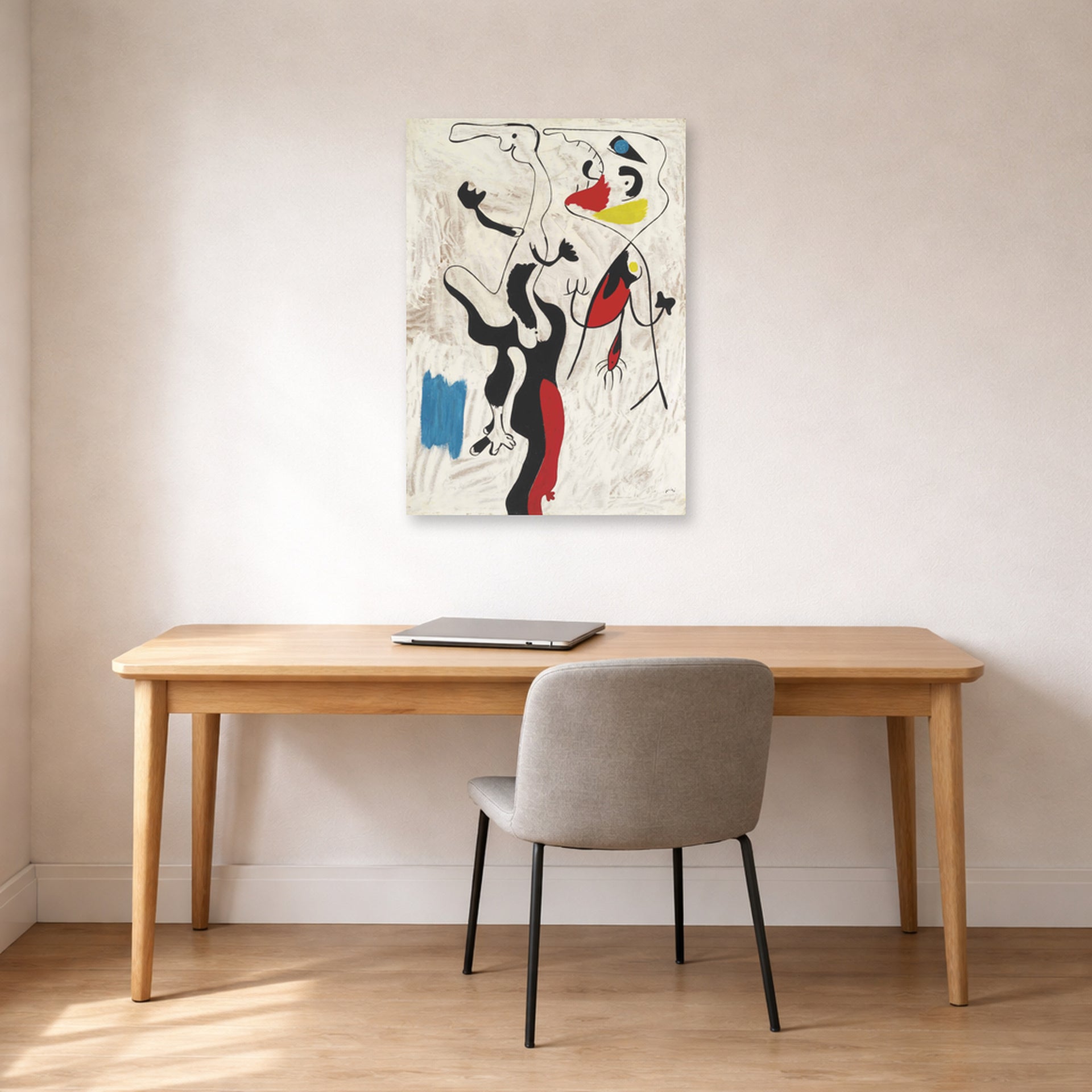 Unframed poster print of Joan Miró's 'Man and Woman' displayed on a wall in a office