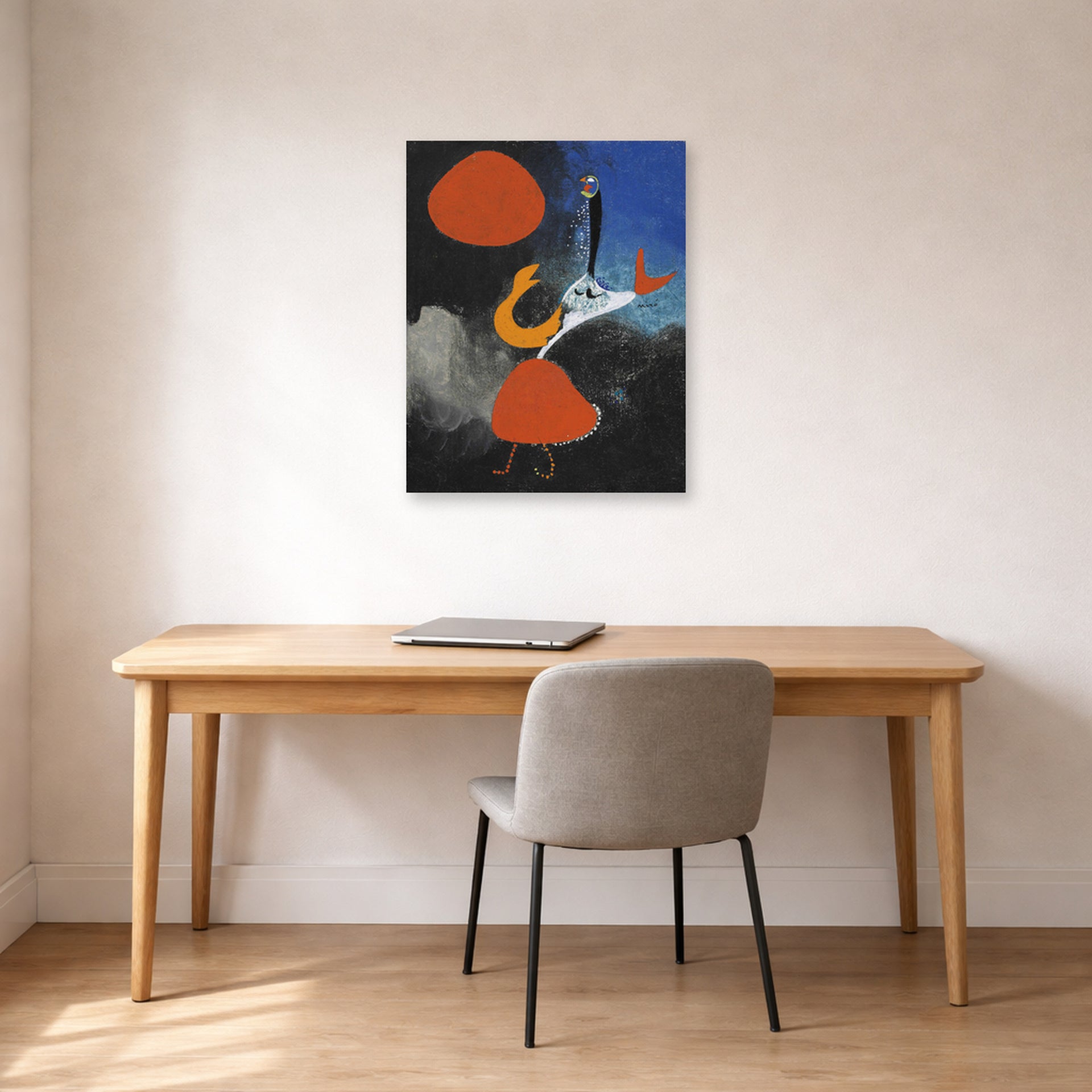 Unframed poster print of Joan Miró's 'Woman in Front of the Sun' displayed on a wall in a office