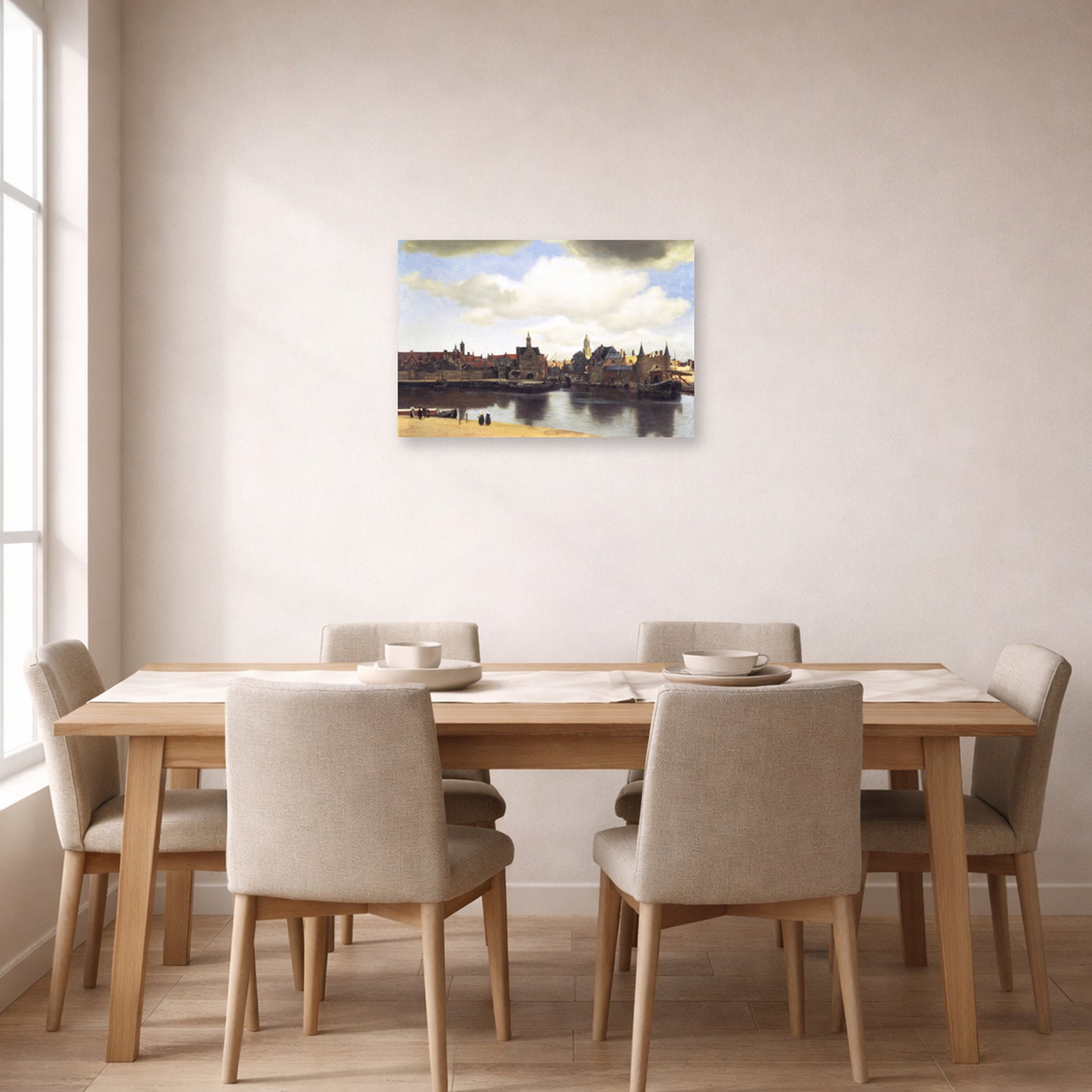 Unframed poster print of Johannes Vermeer's View of Delft displayed on a wall in a dining room