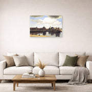 Unframed poster print of Johannes Vermeer's View of Delft displayed on a wall in a living room