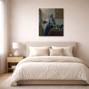 Gallery-wrapped canvas print of Johannes Vermeer's Young Woman with a Water Pitcher displayed on a wall in a bedroom