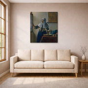 Gallery-wrapped canvas print of Johannes Vermeer's Young Woman with a Water Pitcher displayed on a wall in a living room