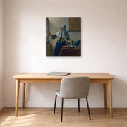 Gallery-wrapped canvas print of Johannes Vermeer's Young Woman with a Water Pitcher displayed on a wall in a office